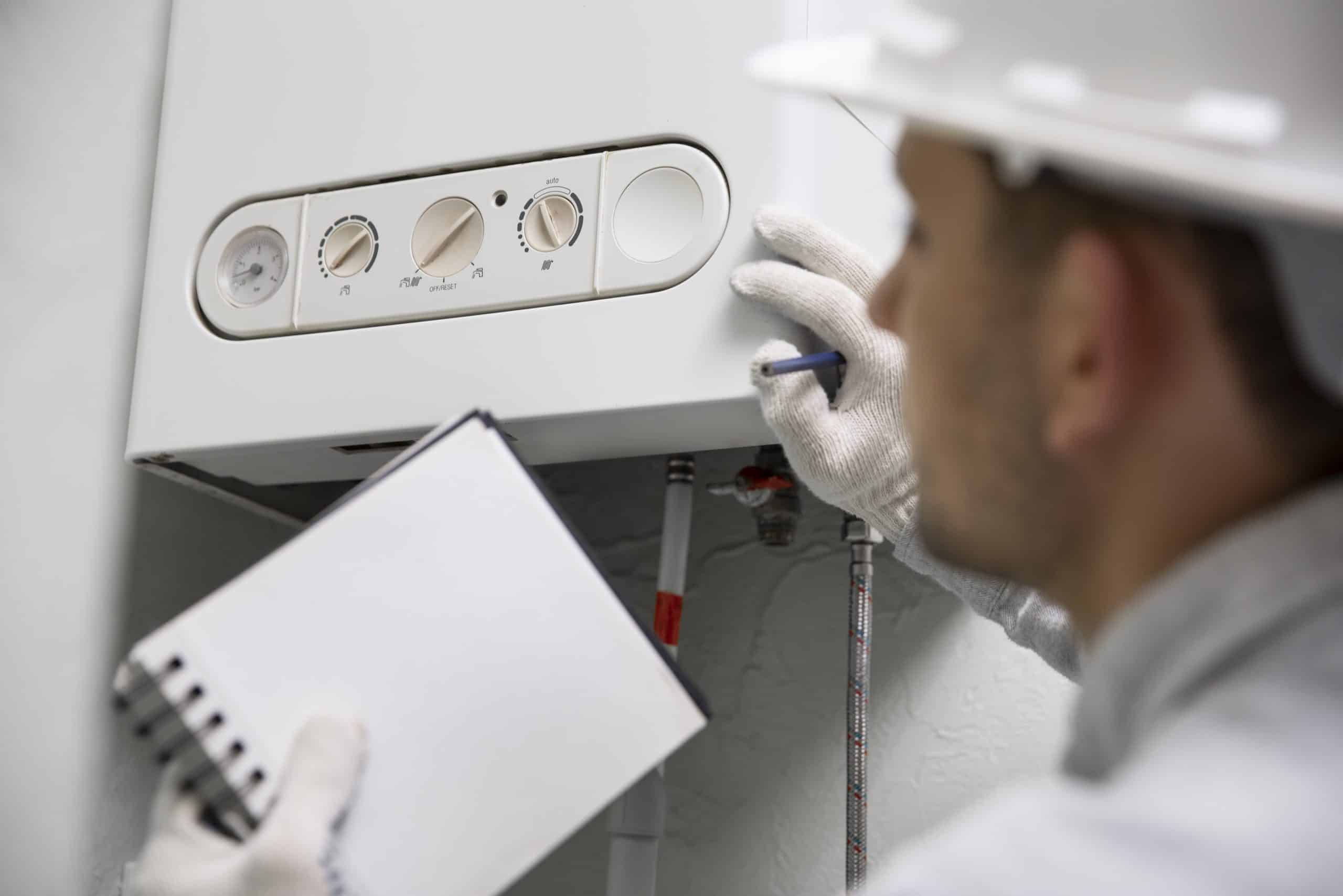 https://installation-climatisation-chauffage.fr/wp-content/uploads/2025/01/worker-repairing-water-heater-scaled.jpg